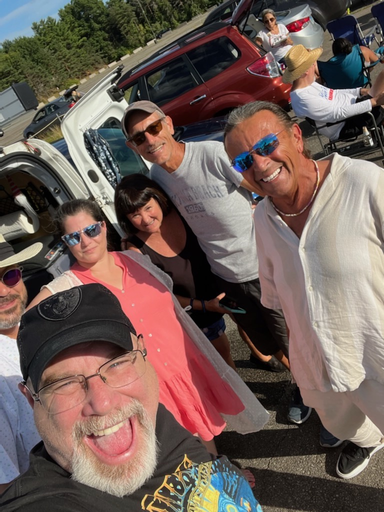 Deflector-Tom-Lanen-publisher-on-right-in-mirror-glasses tailgating for Rod Stewart concert at Xfinity Center Mansfield MA Summer 2022